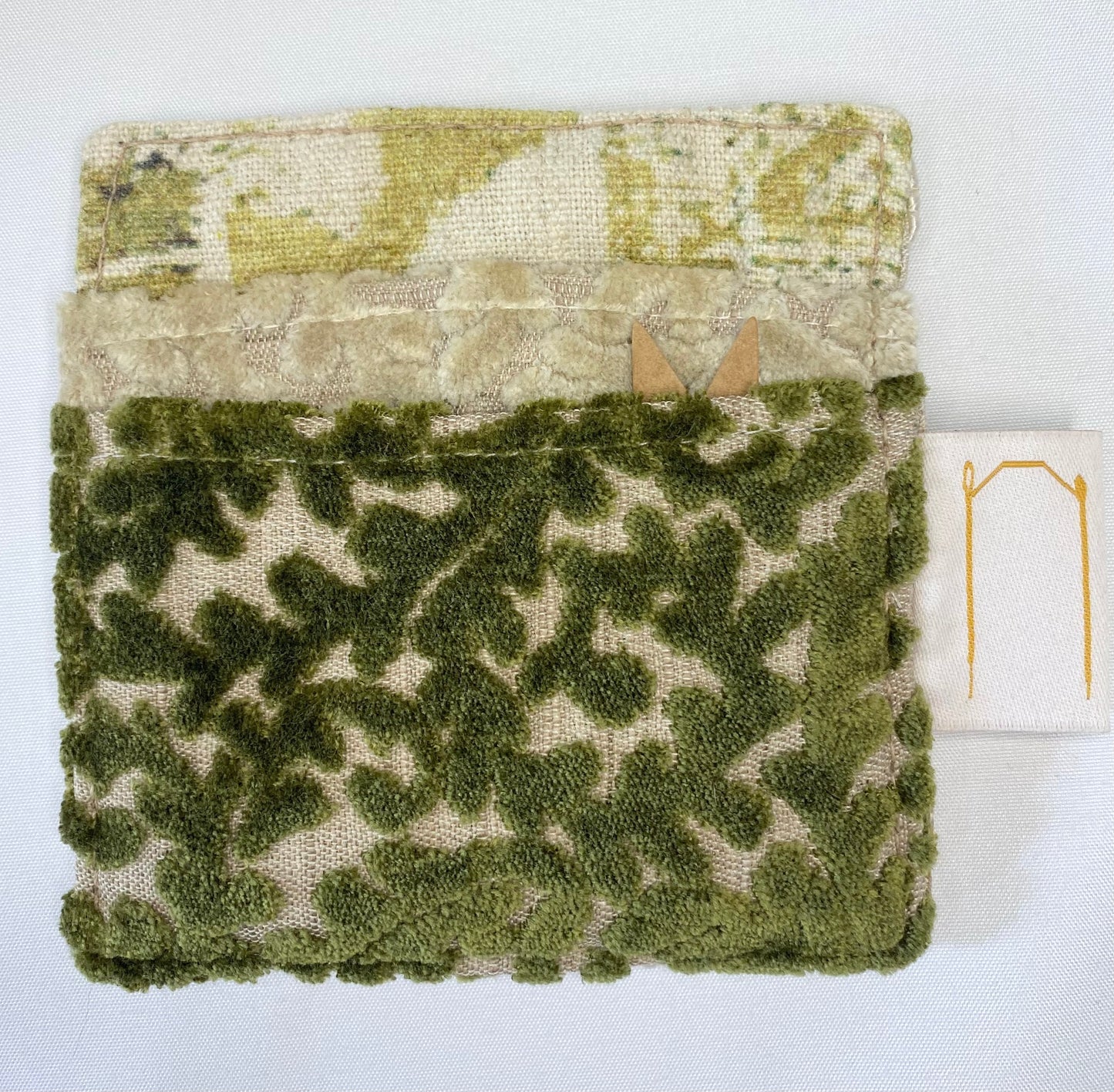 Textured green fabric with a pattern on a white background