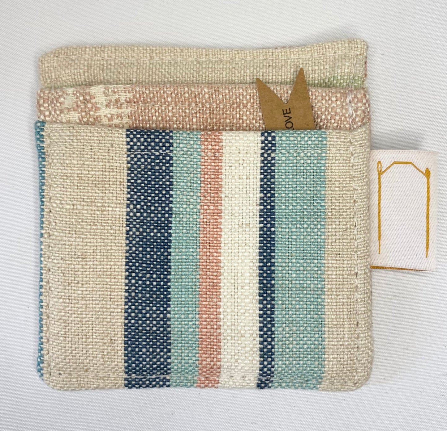 Textured pouch with striped pattern on a light gray background