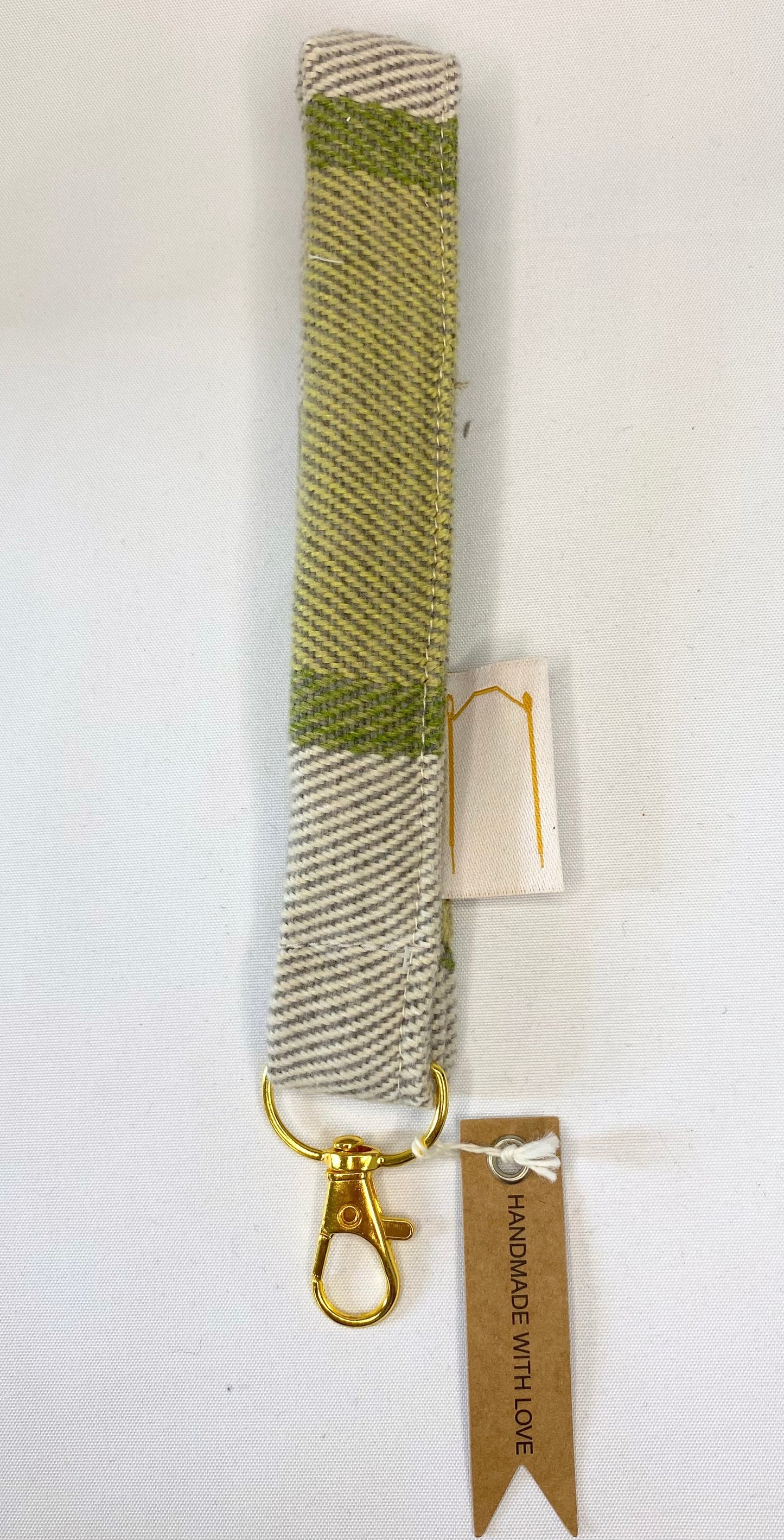 Woven keychain with gold clasp on a white background