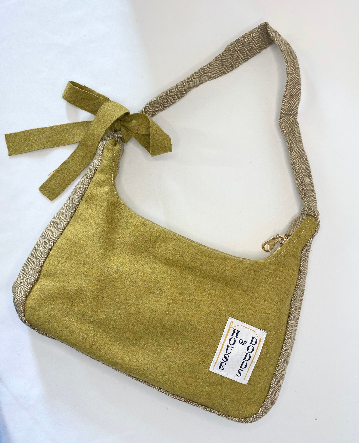 Green handbag with a label on a white background