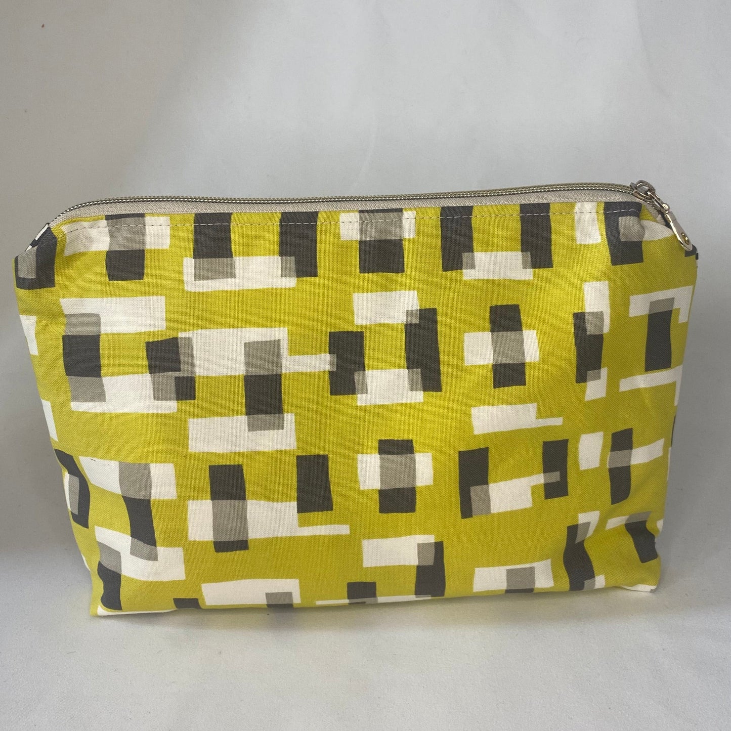 Zipped pouch with geometric pattern on a white background